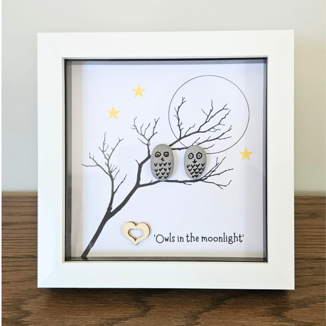 Framed artwork with two owls on a branch under a moon and stars.