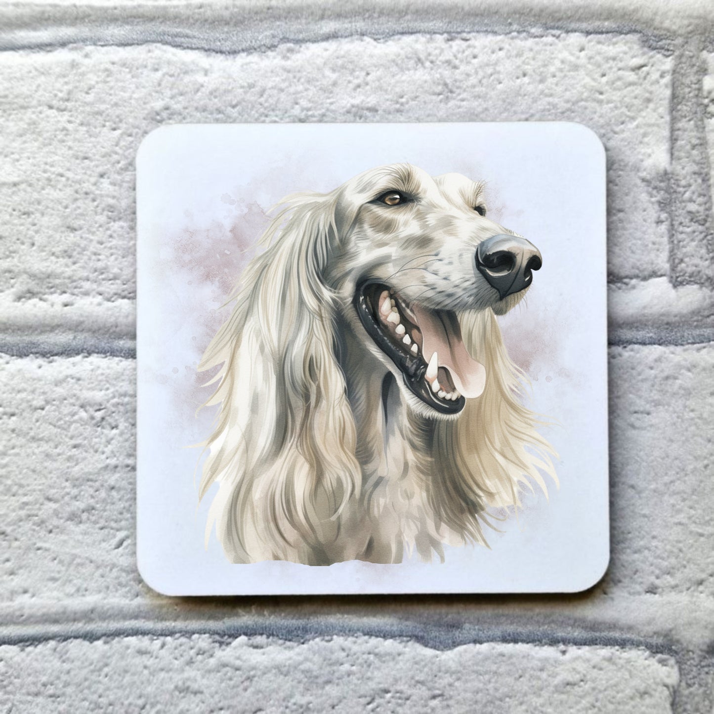 A head shot of a white Afghan Hound with long flowing hair sat facing to the right. A smoky background decorates the image on a white drinks coaster. The coaster is placed on a grey, brick effect surface.