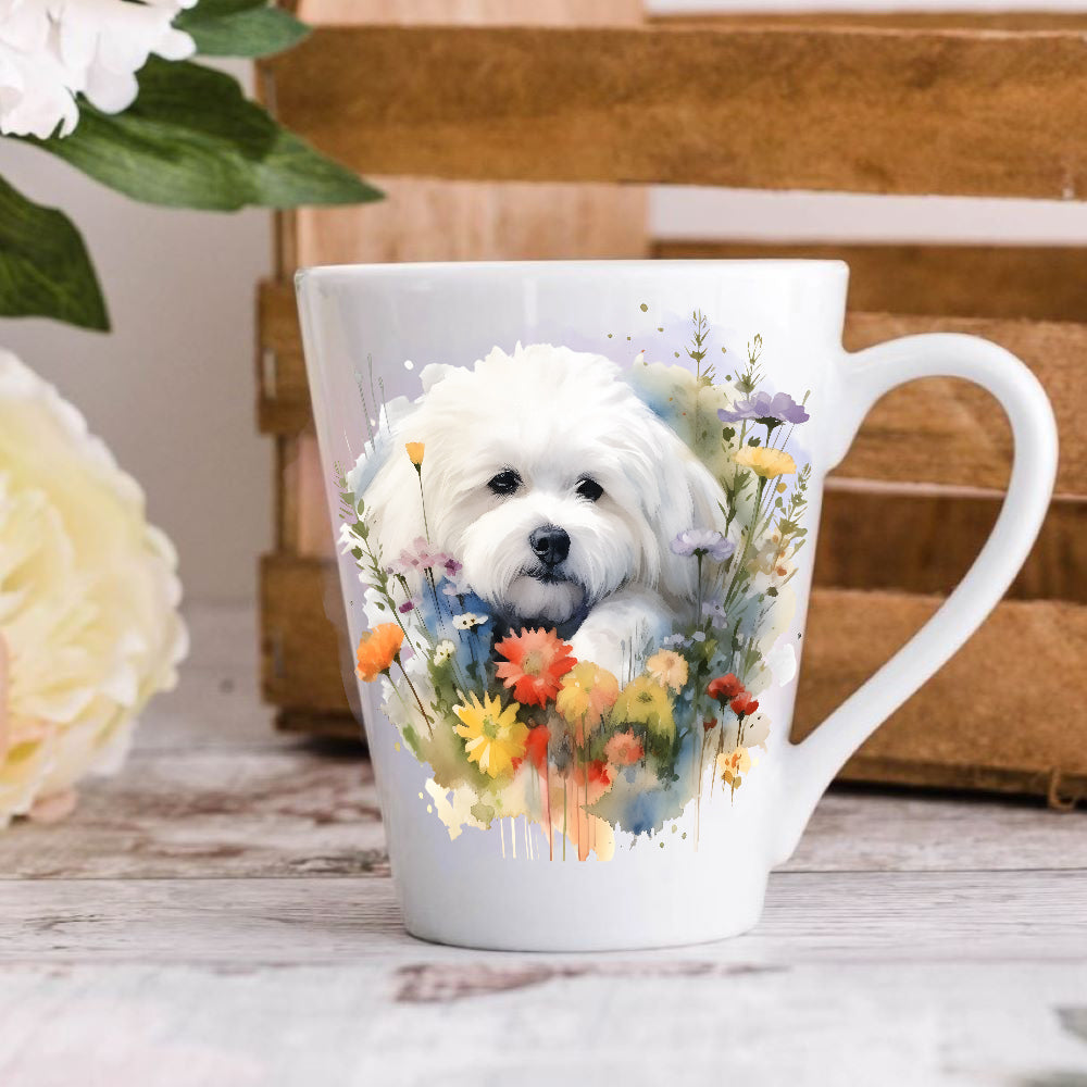 A latte coffee mug with a white ceramic body, featuring a printed image of a Bichon Frise dog surrounded by colourful flowers on the front and back.