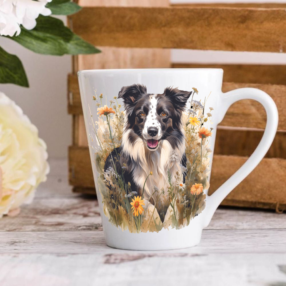 A latte coffee mug with a white base color, featuring a colourful illustration of a Border Collie dog surrounded by flowers, placed on a wooden surface.