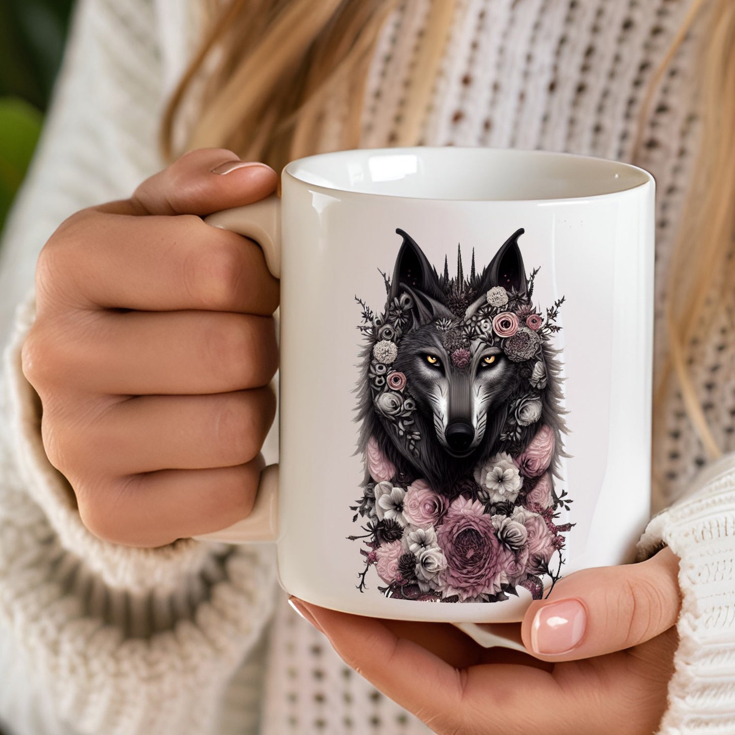 Person holding a mug with a wolf and floral design