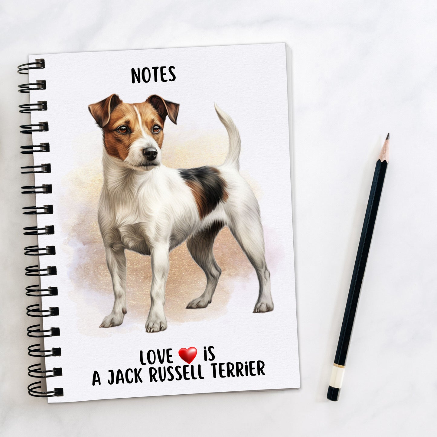 A5 white notebook with black spiral wire binding. A Jack Russell Terrier stands looking towards the right on the front cover. A golden brown background decorates and a black pencil is placed to the right hand side. A quote with a red heart is placed at the bottom of the book.