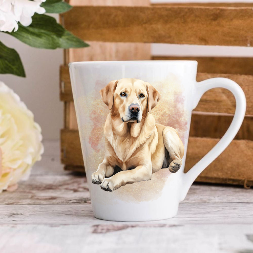 A latte coffee mug with a vibrant image of a yellow labrador retriever on it, placed on a wooden surface with flowers and a crate in the background.