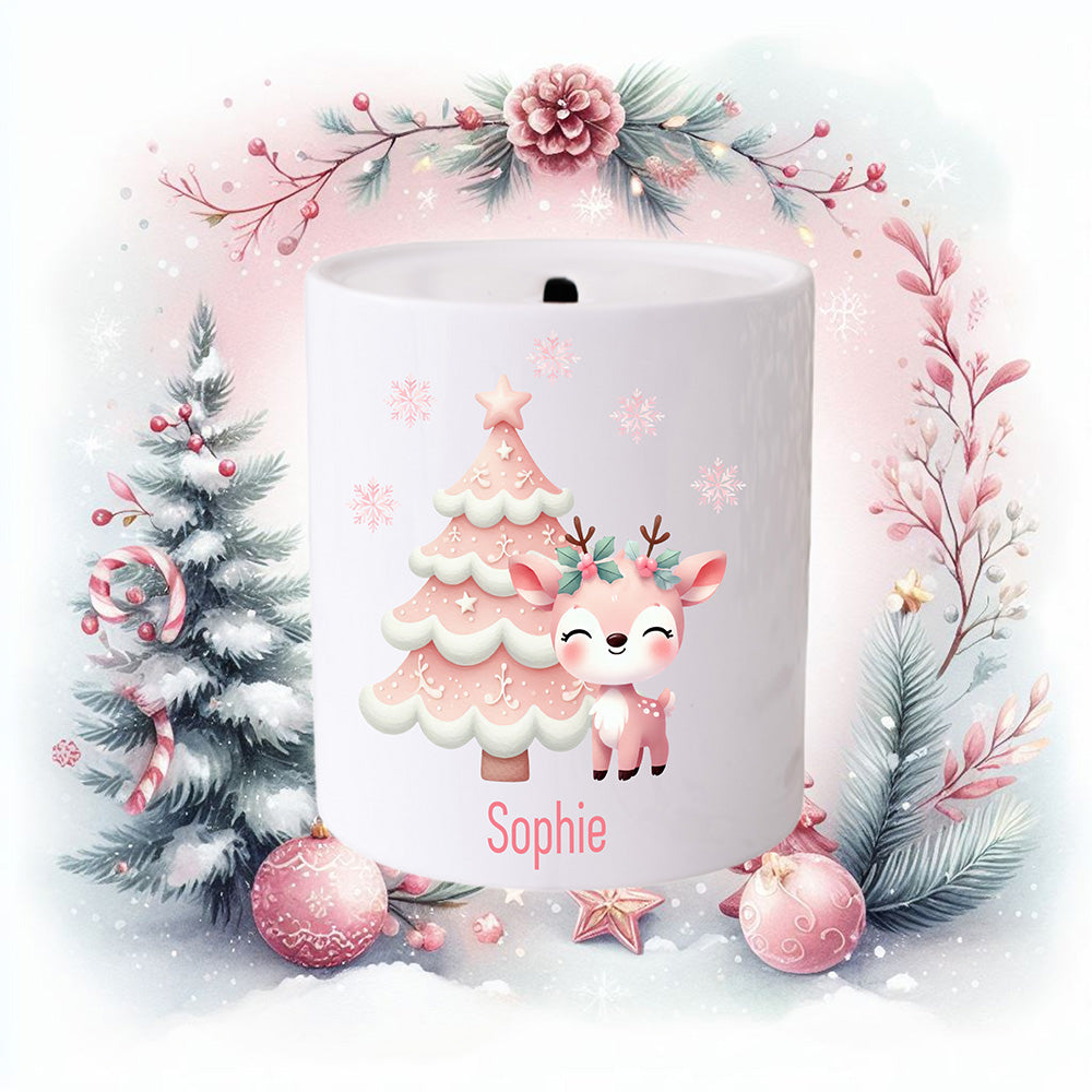 Personalised Christmas money box for a girl. Pink Christmas tree and a pink reindeer. Christmas scene decorates the background.