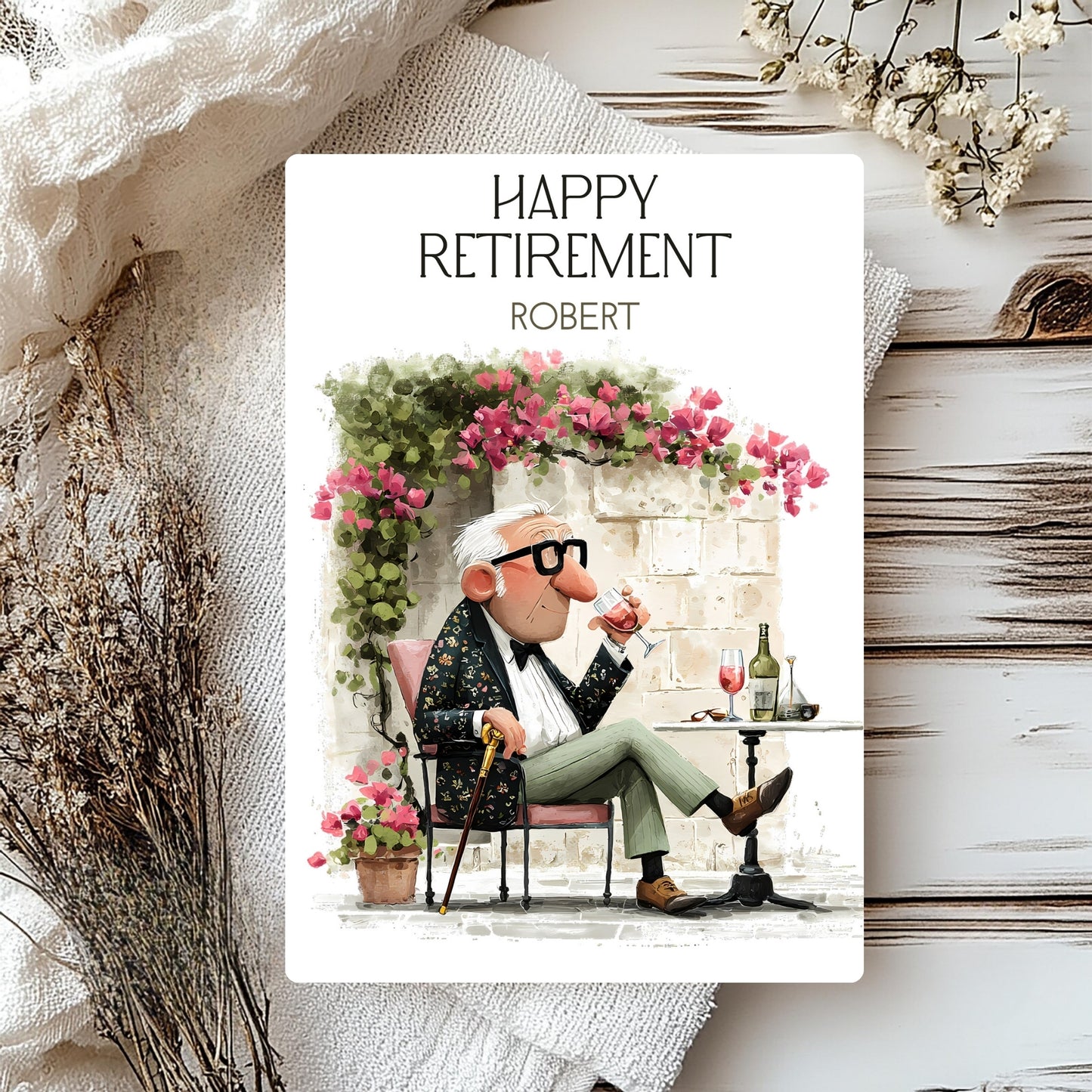 Happy Retirement card with a cartoon character sitting at a table with flowers and wine glasses.