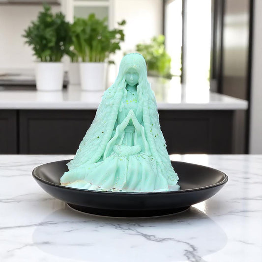 wax melt figurine on a black plate in a kitchen setting