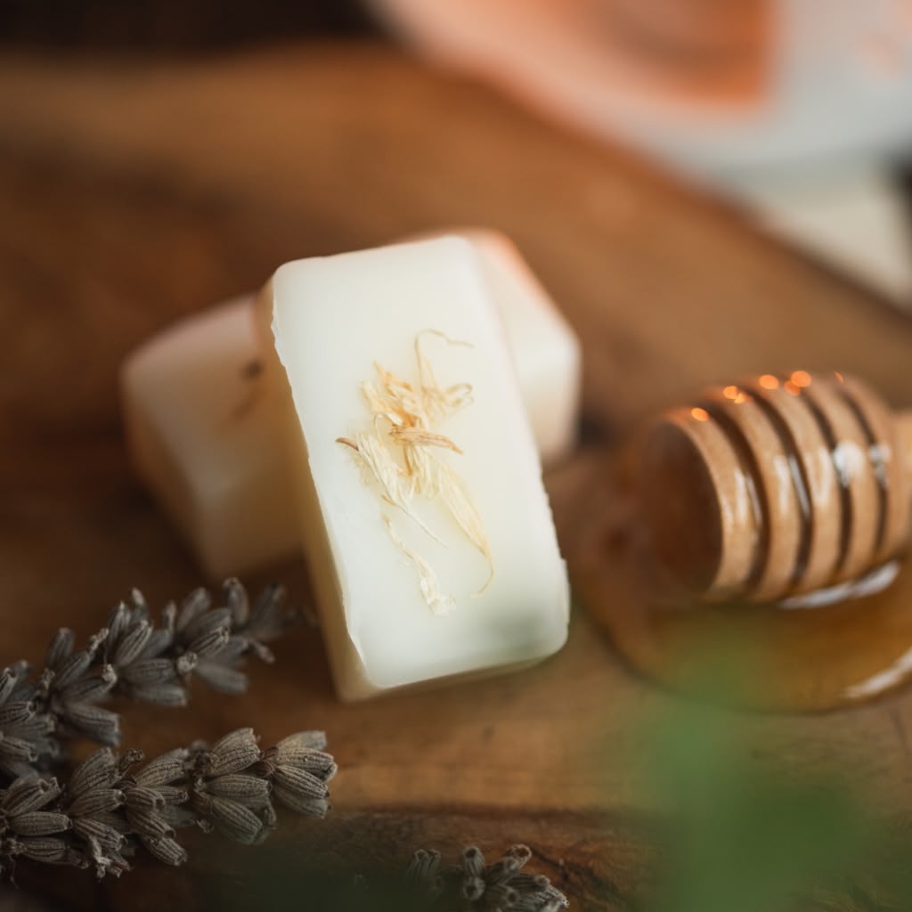 Bar of wax melt with honeycomb and lavender on a wooden surface