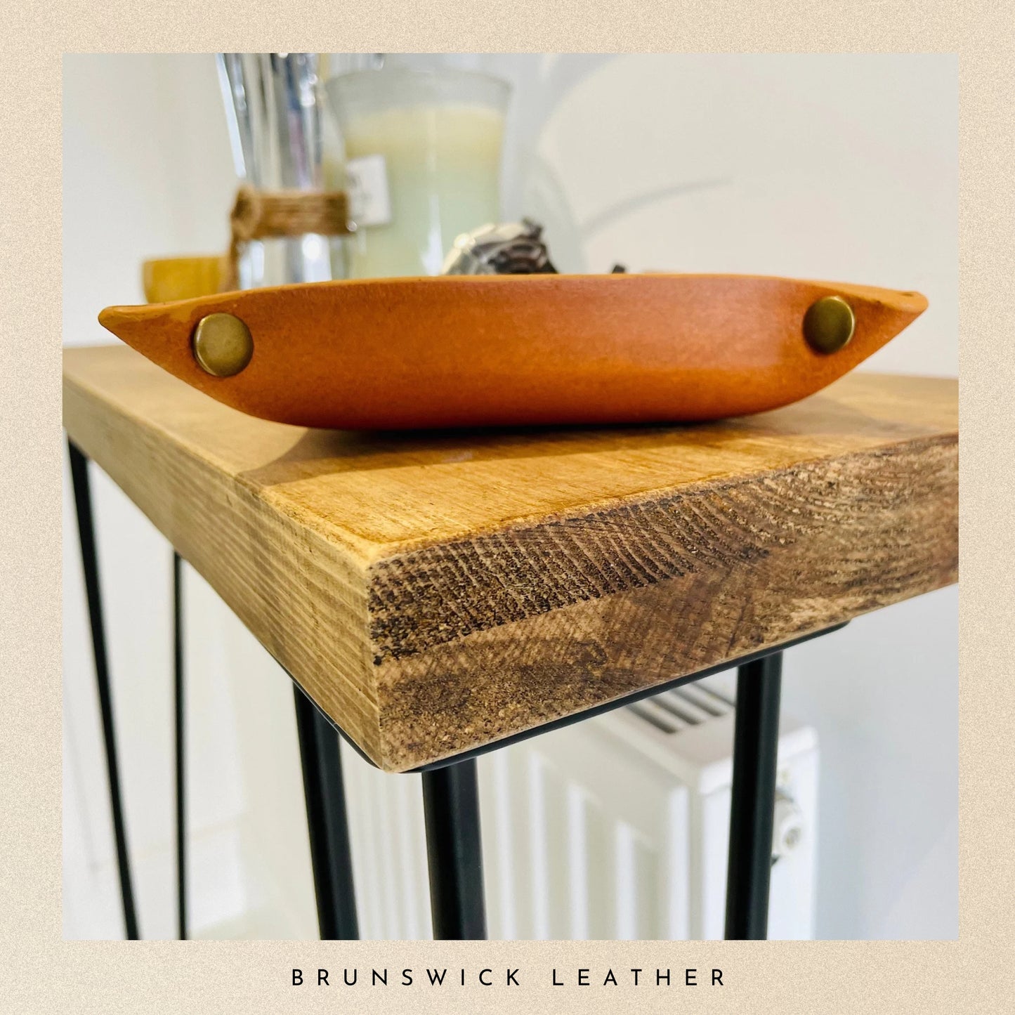 Wooden tray with leather finish on a wooden surface, branded 'Brunswick Leather'.