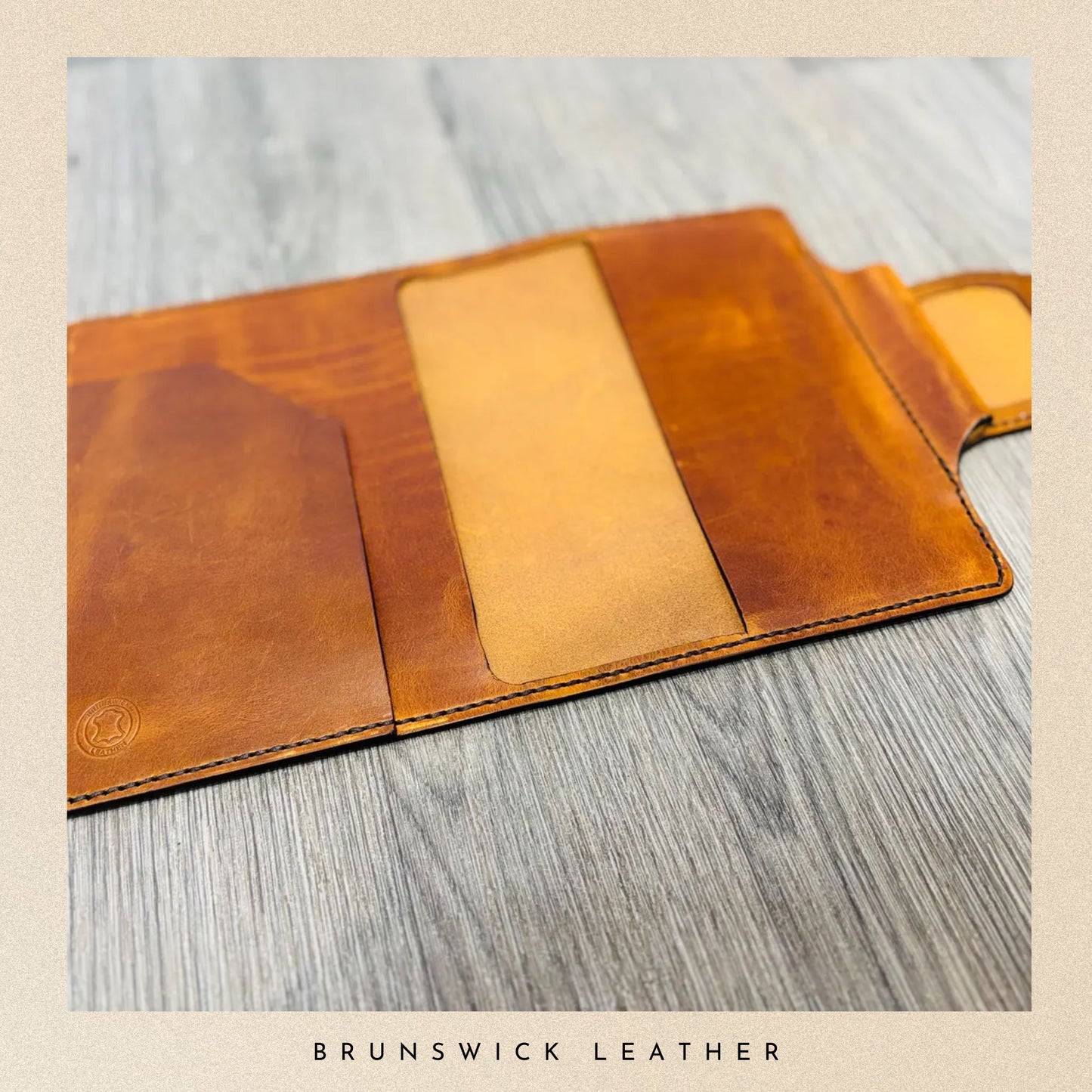 Brown leather wallet on a wooden surface with 'Brunswick Leather' branding.
