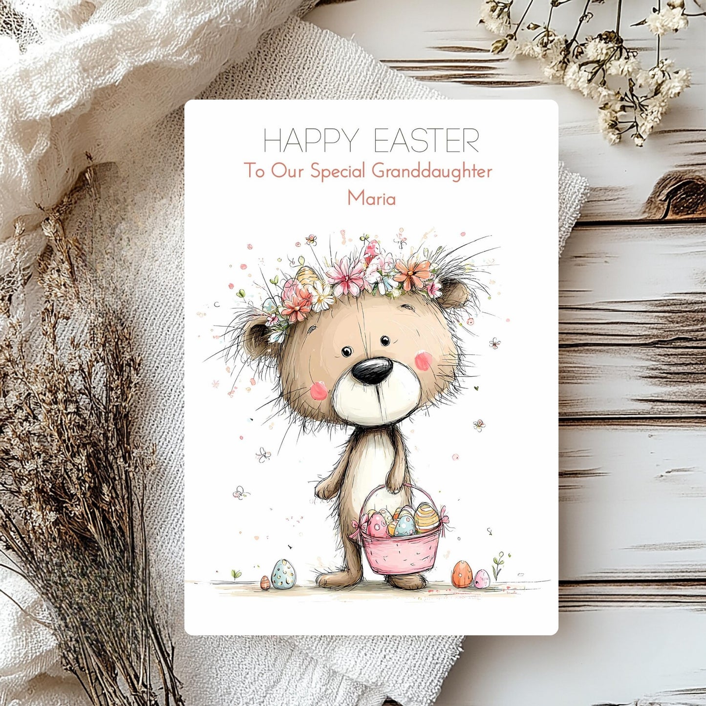 Easter card with a teddy bear holding a basket of eggs, surrounded by flowers and text.