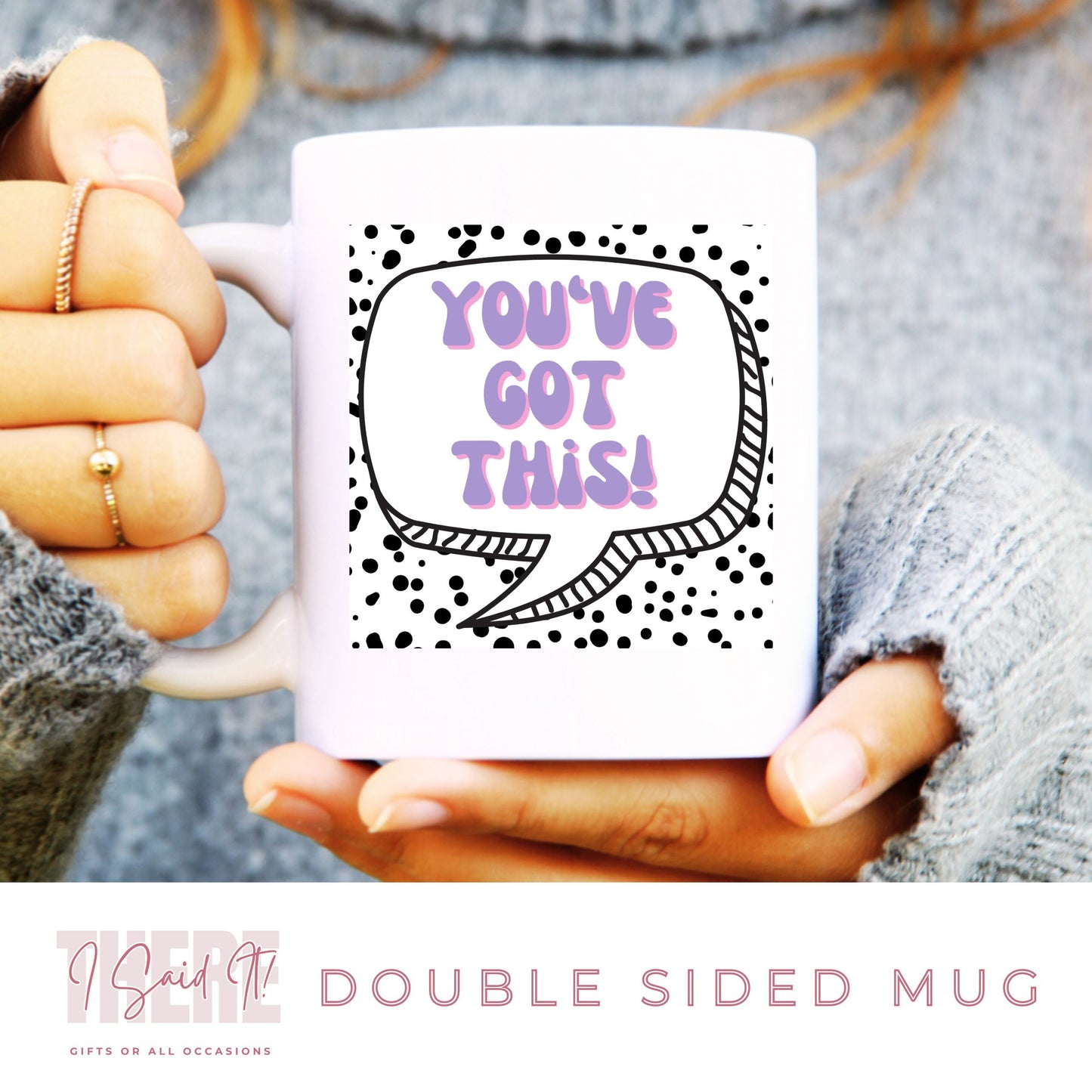 A person holding a white coffee mug with a double-sided print. The mug has text and dot patterns on it.