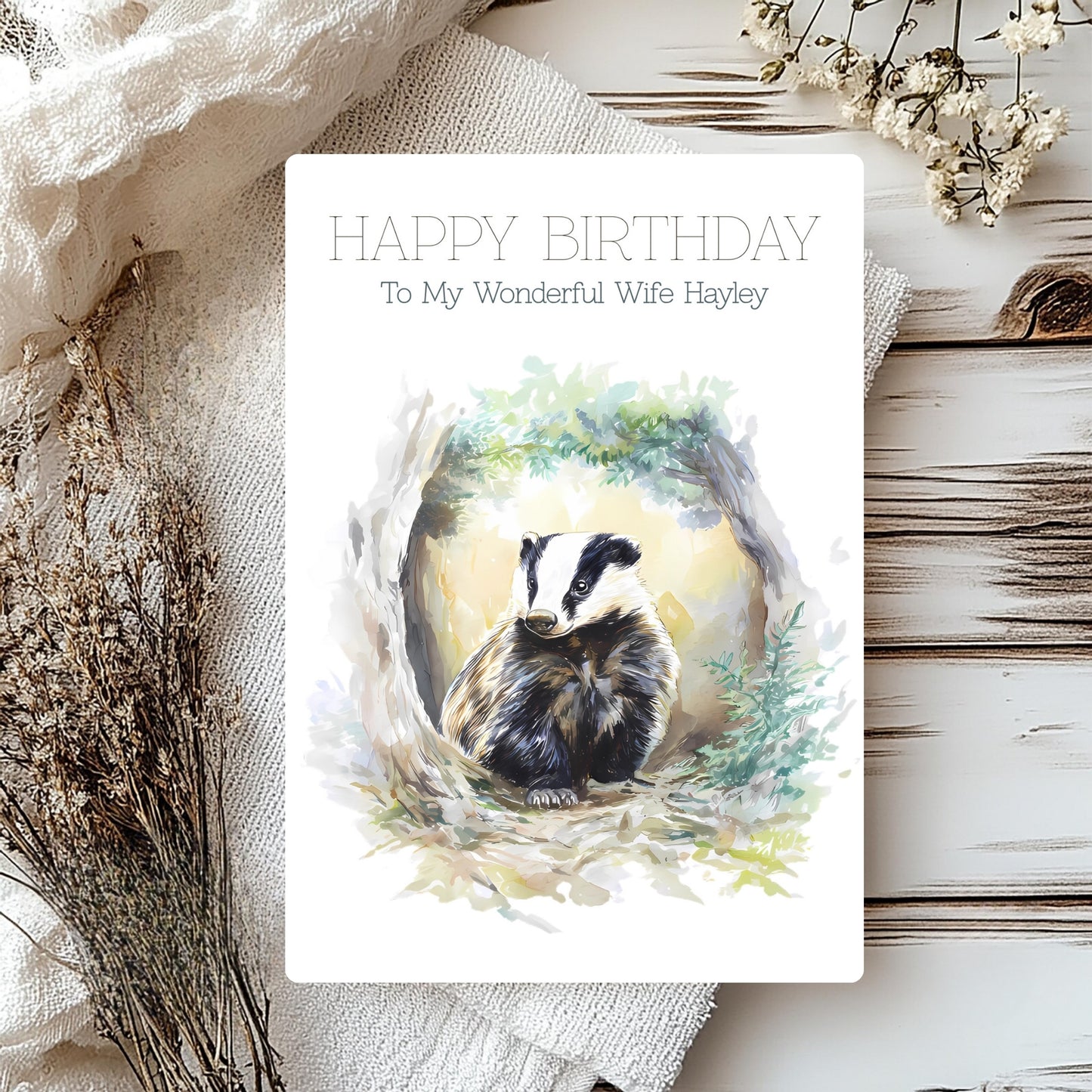 Birthday card with badger illustration and personalised text on a rustic background