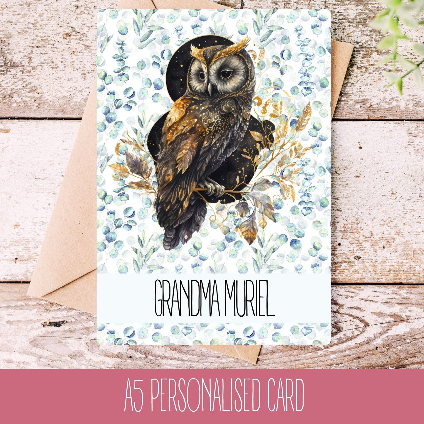 Personalised handmade owl greetings card with the name Grandma Muriel printed on it, placed on a wooden surface with a white envelope.