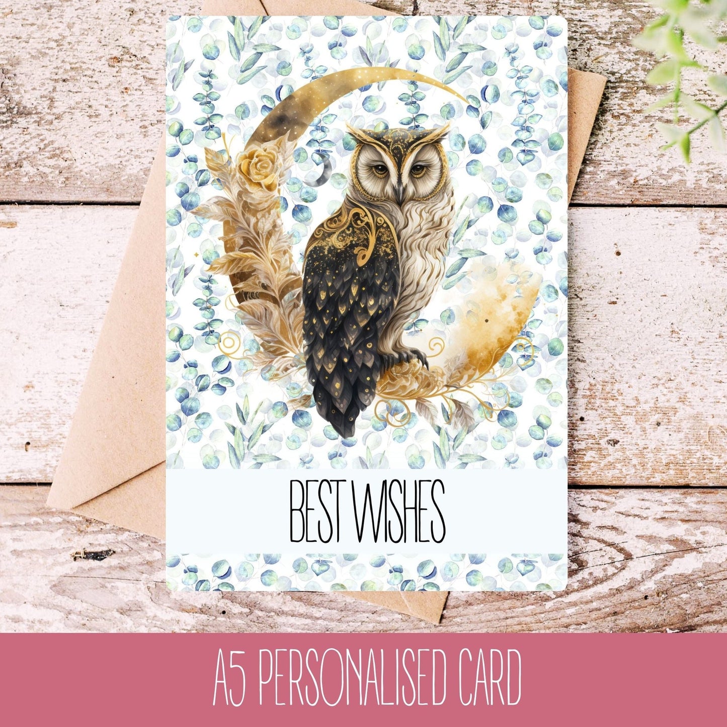A personalised handmade owl occasion card with floral patterns and the text 'BEST WISHES' on the front, placed on a wooden surface with a kraft paper envelope behind it.