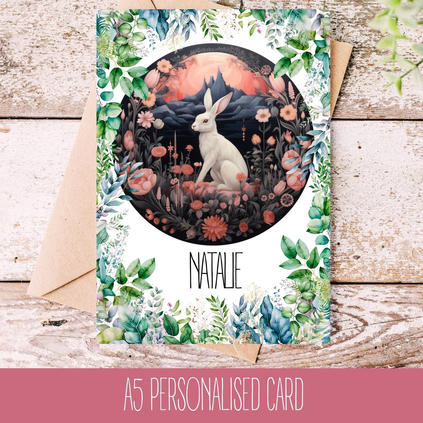 A personalised greeting card featuring an illustration of a hare among flowers and a nightscape in the background, with the name 'Natelle' printed on the front.