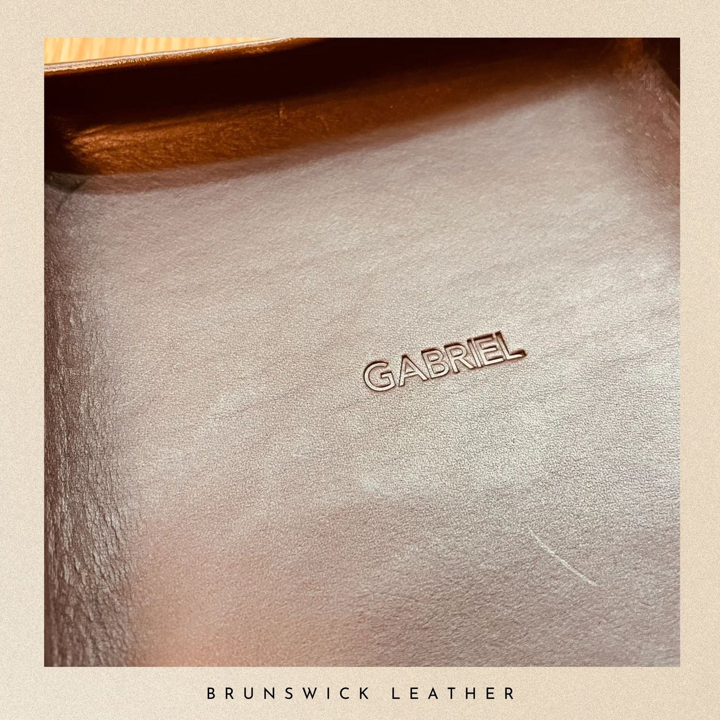 Close-up of a leather surface with 'GABRIEL' branding, labeled 'Brunswick Leather'.