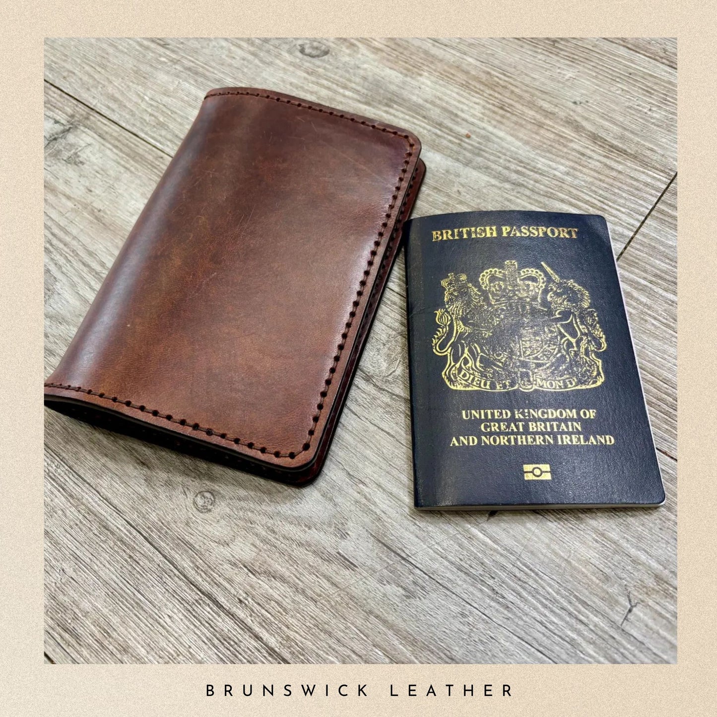 Brown leather wallet and British passport on a wooden surface with 'Brunswick Leather' branding.