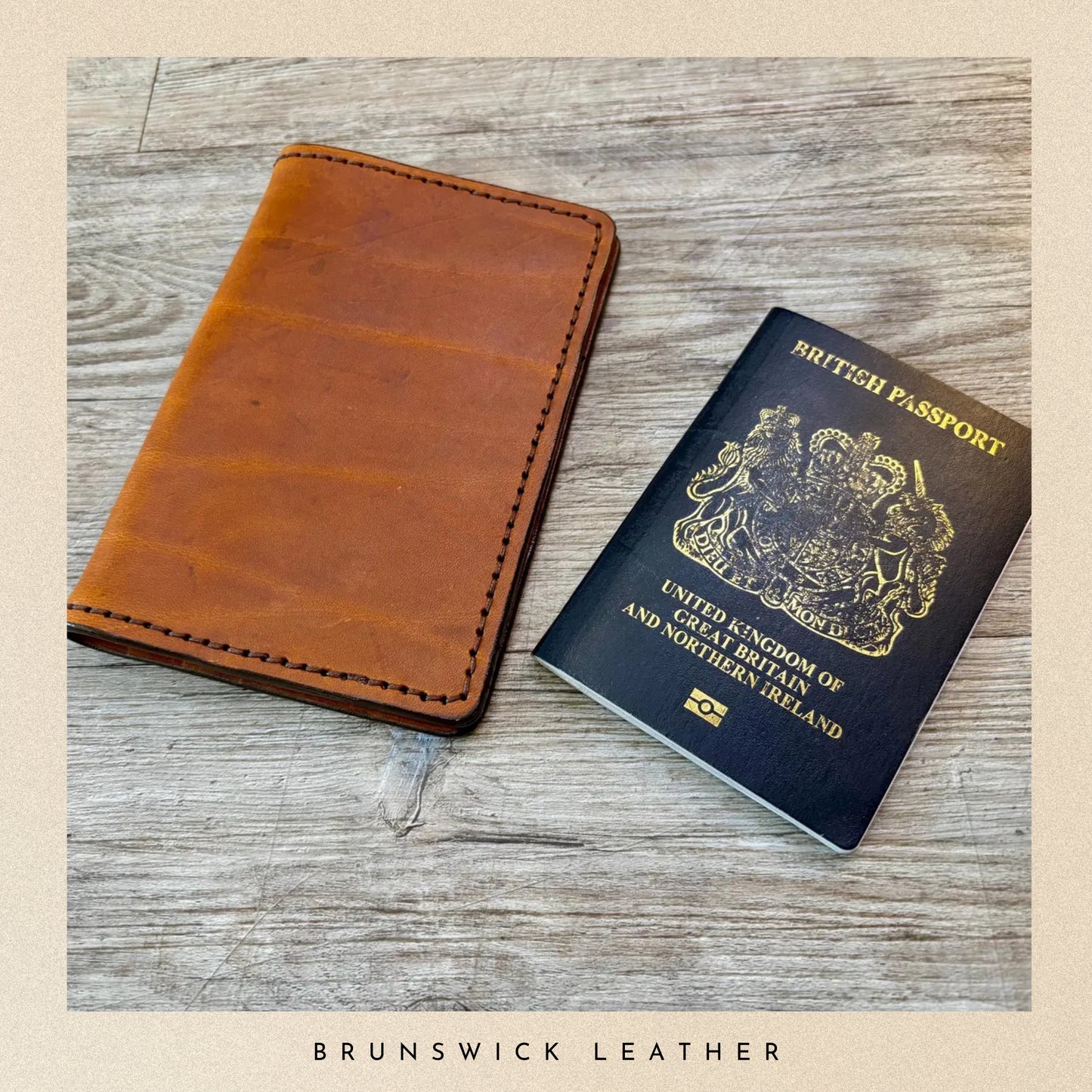 Brown leather wallet and British passport on a wooden surface with 'Brunswick Leather' branding.