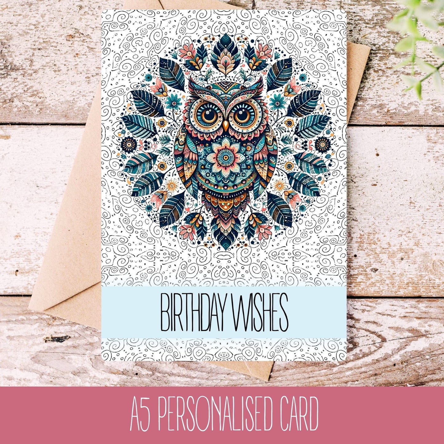 A personalised greeting card with a mandala owl design, the card is placed on a wooden surface with a 'Birthday Wishes' text visible, and it comes with a white envelope.