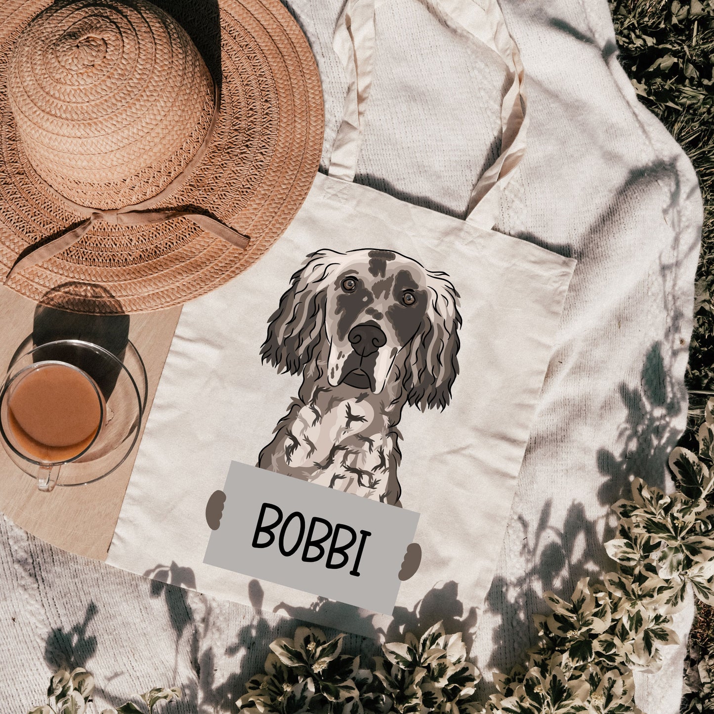 A white cotton tote bag with a printed grayscale illustration of an English Setter dog and the name 'BOBBI' below it.