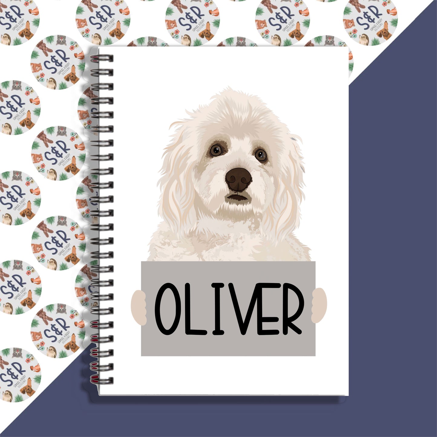 A notebook with a spiral binding featuring a graphic of a Havanese dog on the front cover, with the name 'Oliver' printed on the page.
