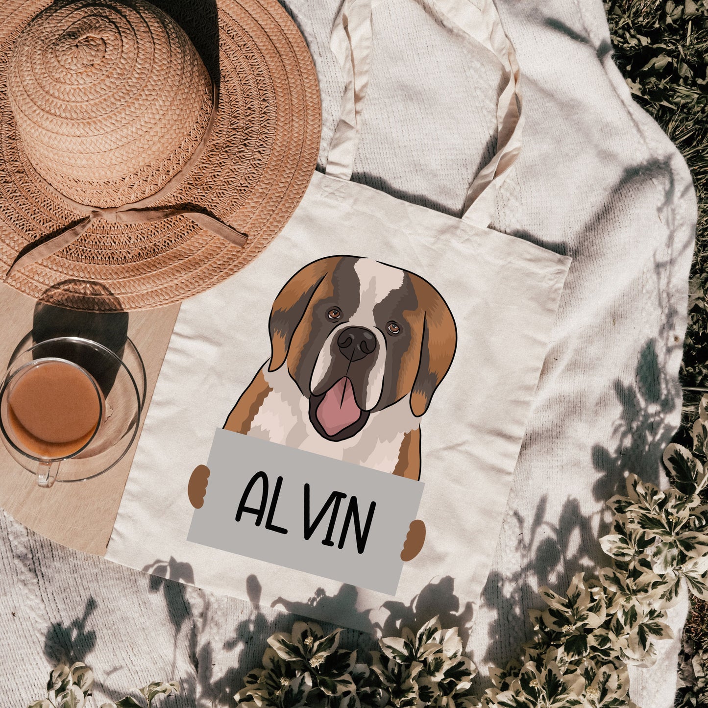 A personalised tote bag with an illustration of a Saint Bernard dog on it, with the name 'Alvin' printed on the front.