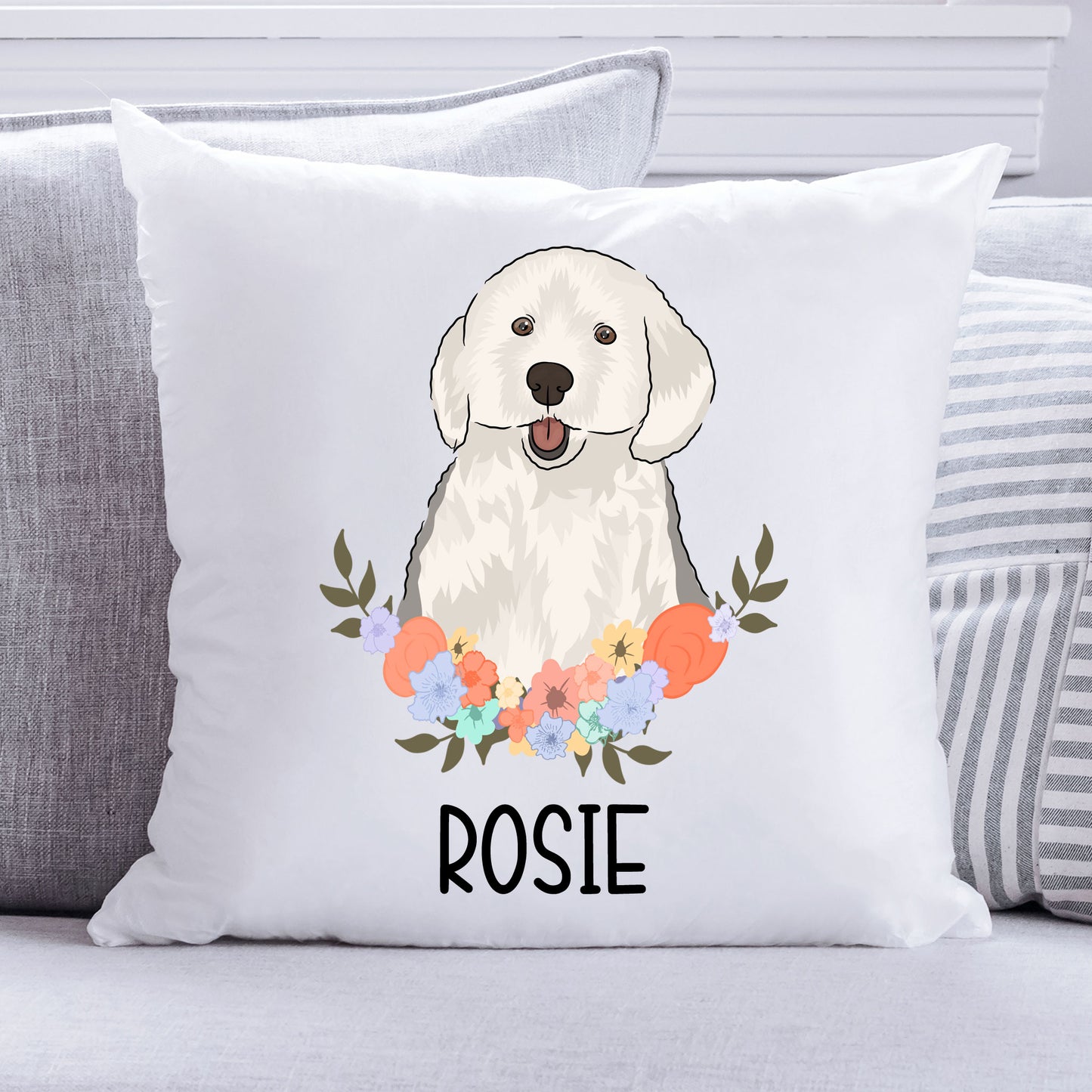 A personalised cushion featuring an illustration of an English Sheepdog in the center with a floral pattern around it, on a white background.