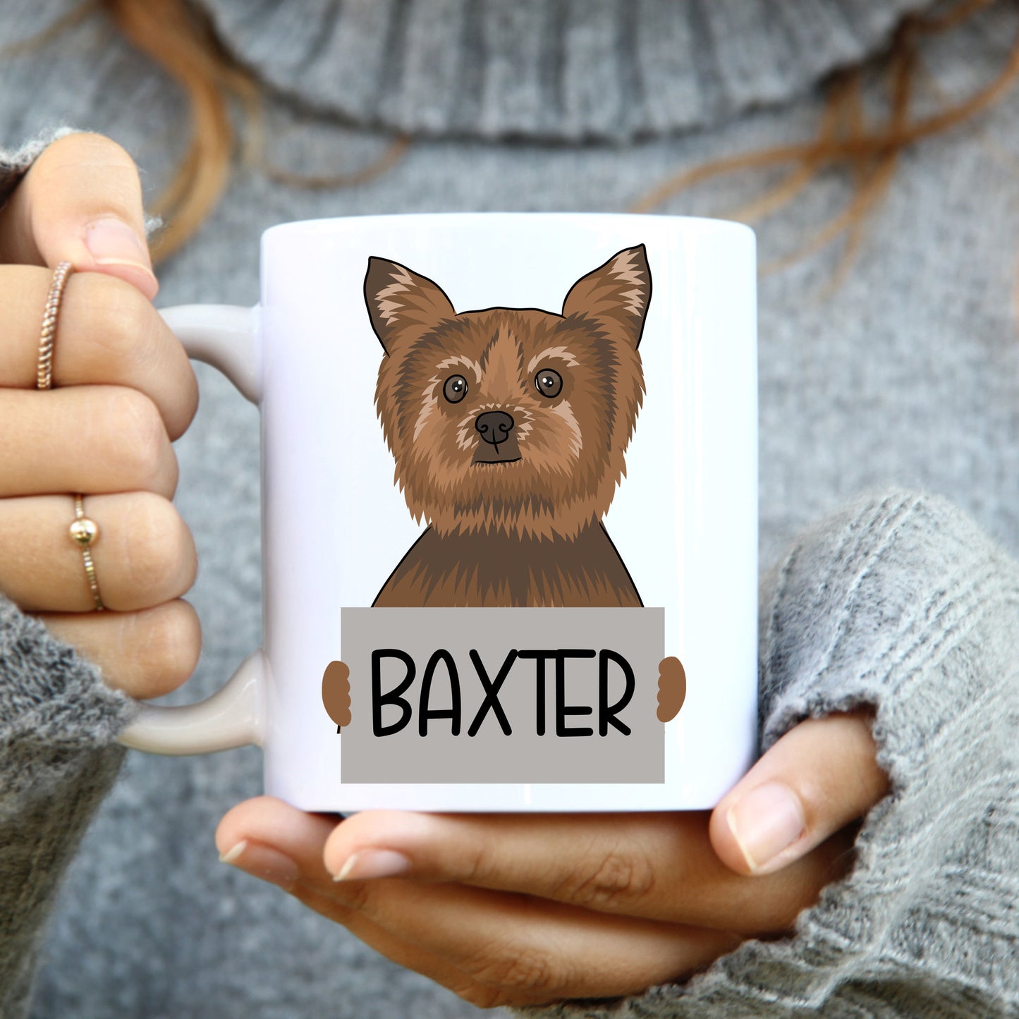 A coffee mug with a colorful illustration of a Yorkshire Terrier dog on the side, with the name 'Baxter' printed below the image.