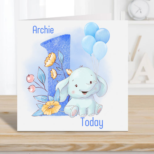 Boy 1st birthday card. Personalised with a name. Blue number with floral decoration. Blue baby elephant and balloons.