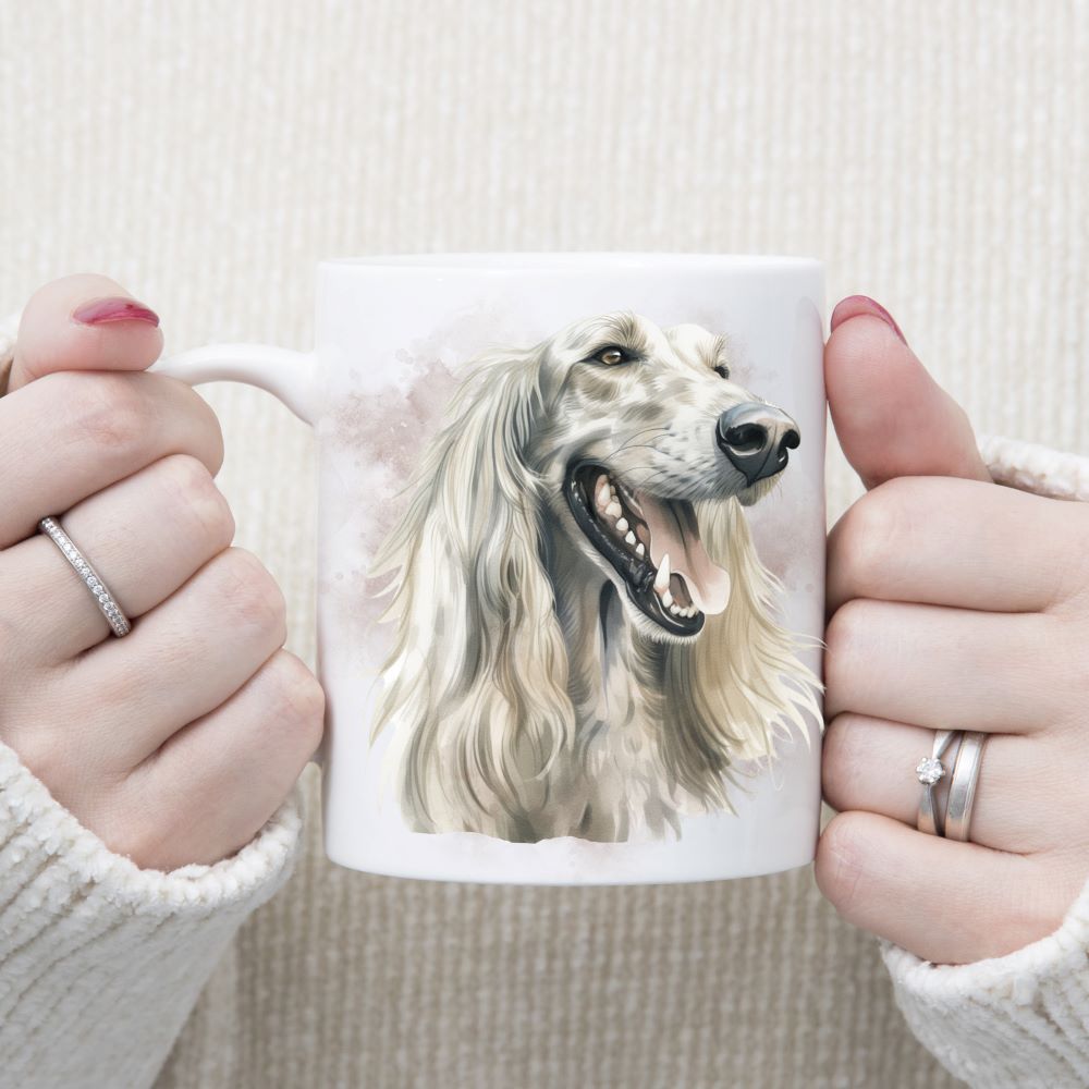 A white Afghan Hound with long flowing hair adorns a white ceramic mug. The mug is being held by a woman with both hands.