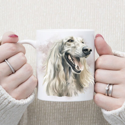 A white Afghan Hound with long flowing hair adorns a white ceramic mug. The mug is being held by a woman with both hands.
