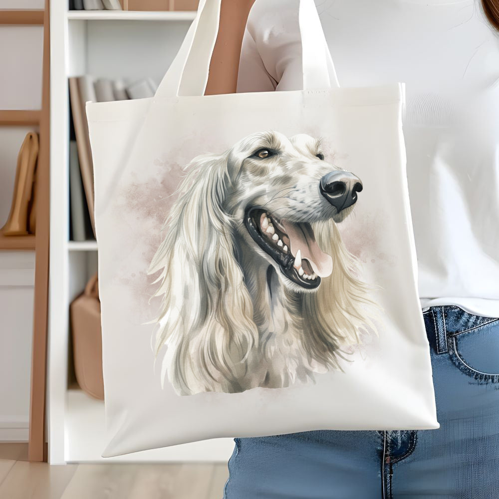 White long handled tote bag showing a a white Afghan Hound head shot.  A woman is holding the bag  in front of white book case.