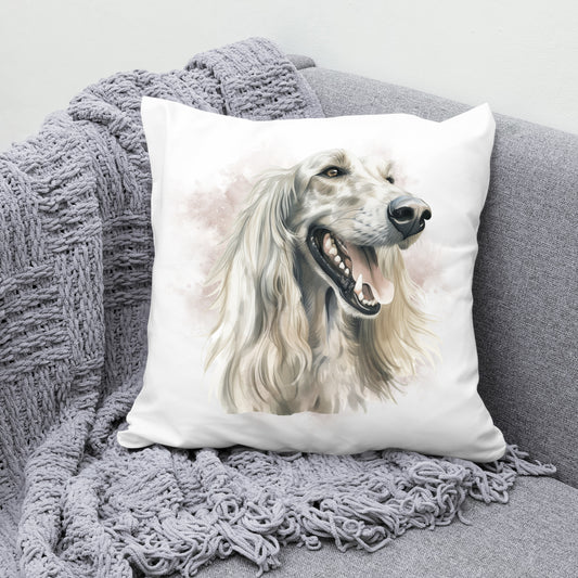 Afghan Hound head shot facing right with a smokey brown background on a white Cushion. The cushion is placed in a the corner of a grey sofa with a grey knitted blanket draped across the corner.