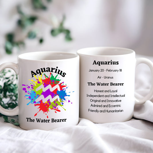 A white ceramic mug with a colourful abstract design, featuring the text 'Aquarius' and 'The Water Bearer', along with a brief description of the Aquarius zodiac sign.