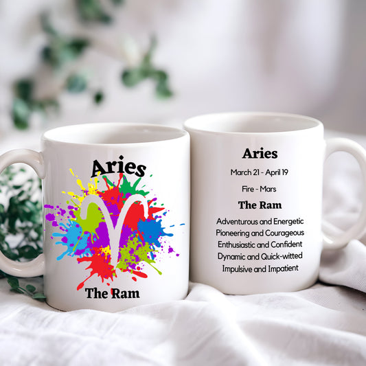 Two white ceramic mugs with a colorful abstract design and 'Aries' text, one displaying additional information about the Aries zodiac sign.