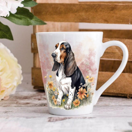 A ceramic latte mug with a printed image of a basset hound, surrounded by floral designs.