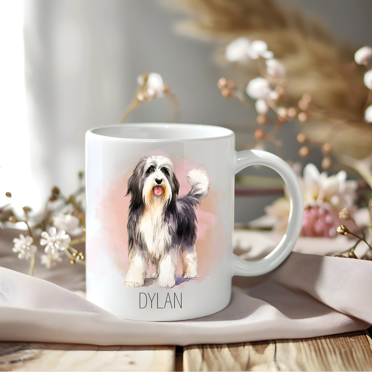 Standing Bearded Collie with a pinkish smoky background on a white personalised mug.  Floral arrangements sit behind.