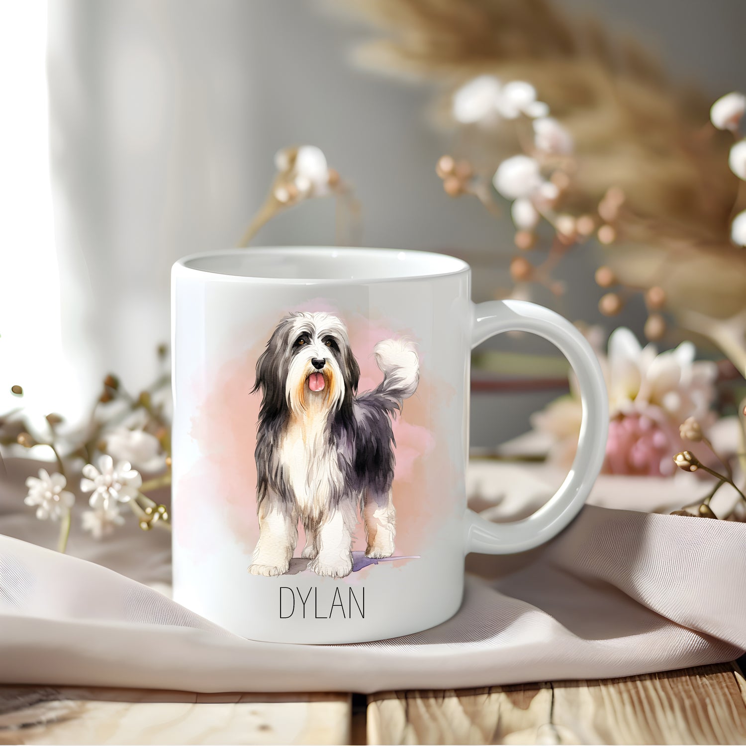 Standing Bearded Collie with a pinkish smoky background on a white personalised mug.  Floral arrangements sit behind.