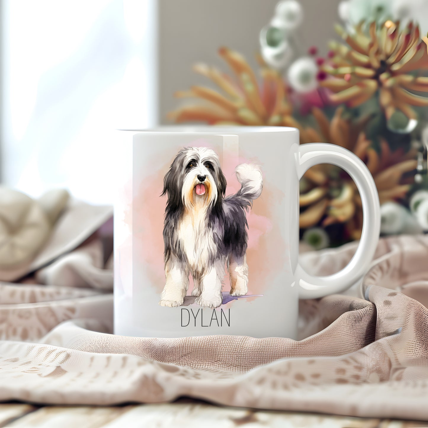 Personalised white ceramic mug.  Image of a lovely Bearded Collie, mouth ope and tongue out. Floral arrangement in the background.