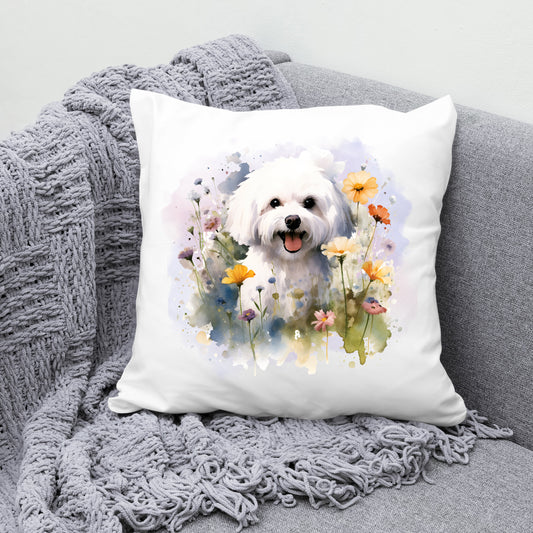 White cushion featuring a vibrant printed image of a Bichon Frise dog sat among various flowers and with a lilac smokey background. The cushion is placed on a grey sofa with a grey blanket across the corner.