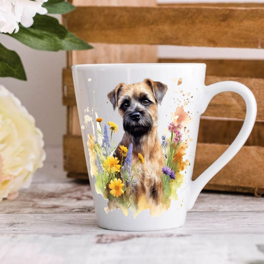 A white ceramic latte mug with a colourful illustration of a Border Terrier surrounded by flowers on the front.