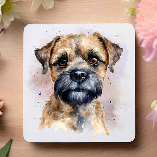 White coaster featuring a printed image of a Border Terrrier head shot on a smokey background.  Coaster is placed on a wooden surface.