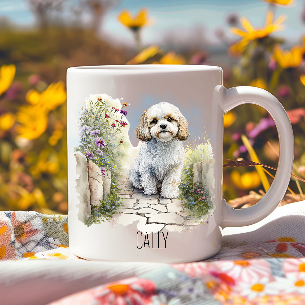 Bright yellow flowers surround this lovely personalised ceramic mug depicting a seated Cavachon.  The mug is placed on a floral multicoloured tablecloth.