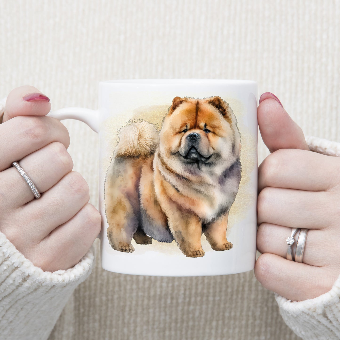 A standing Chow Chow dog with a very cute expression adorns this white ceramic mug.  A gold misty background decorates the mug which is being held by a woman with both hands.