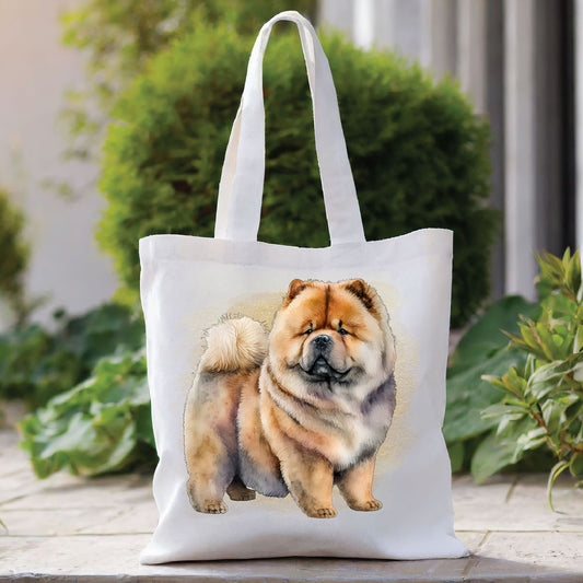 White tote bag with a long handle showing a standing Chow Chow dog in front of a gold coloured background. The bag is placed in front of a large green shrub with green foliage to the right side.