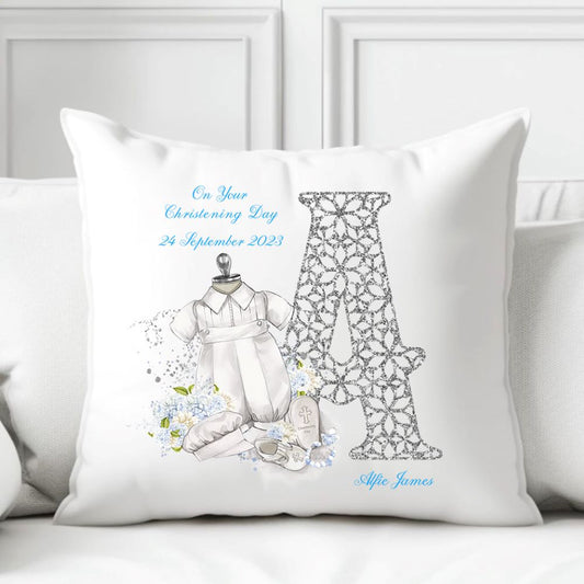 Personalised White Christening Cushion for a Boy featuring a large initial and a Christening suit, shoes and blue flowers.