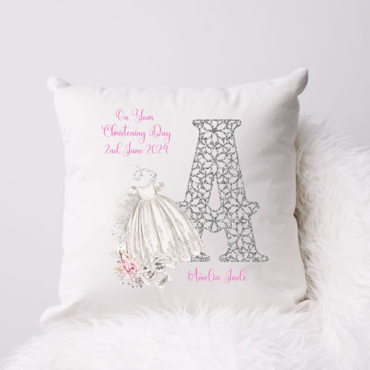 Personalised White Christening Cushion for a Girl featuring a large initial and a Christening gown, shoes and pink flowers.