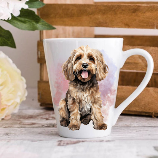 A ceramic latte mug with an image of a Cockapoo dog, featuring a white base and a multicolor floral design on the side.