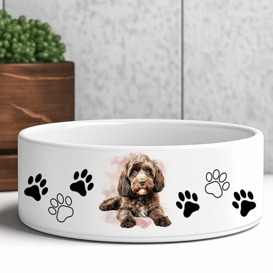 chocolate cockapoo dog bowl decorated with paw prints. Grey background and green plant