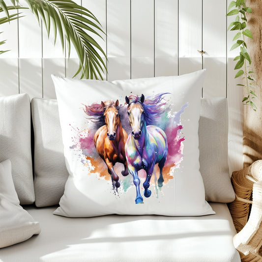 Two Horses running forward. Multi-colours decorate background on the front of a white cushion. The cushion is placed on a cream sofa. White panels and green fern create the background.